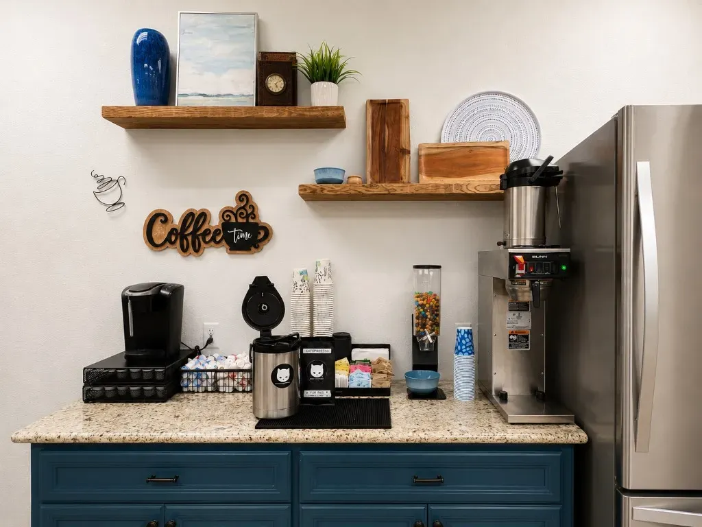 Refreshment and coffee bar with cabinetry, brewing station, and refrigerator