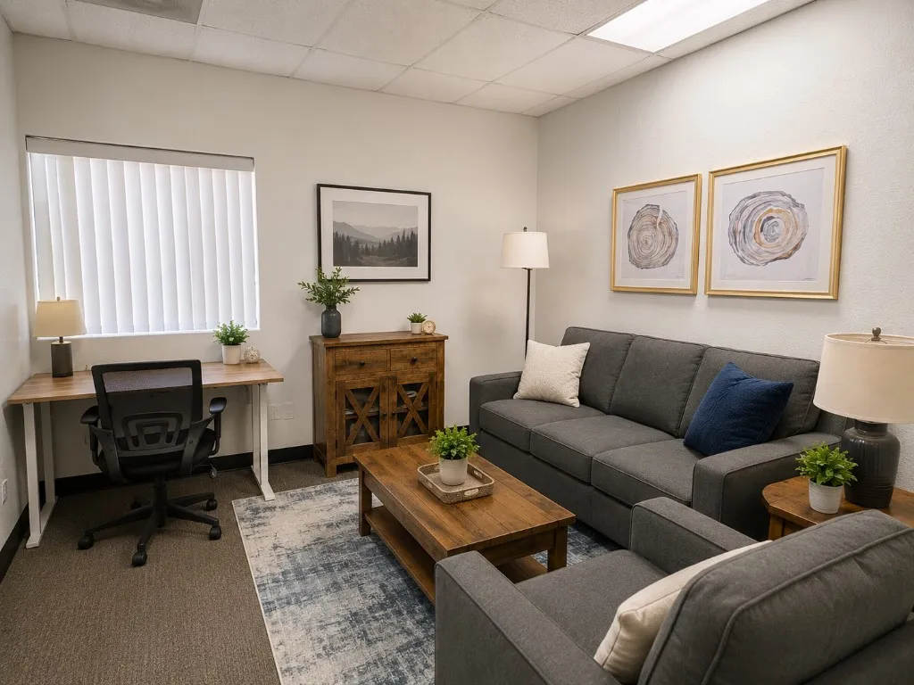 Private office with desk workspace and sofa seating area suited for client meetings